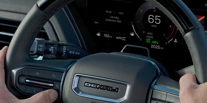 Close-up of Denali steering wheel with digital dashboard showing speed.