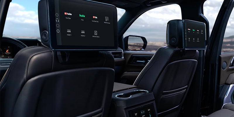 Rear seat entertainment screens in GMC showing streaming apps like YouTube and Hulu.